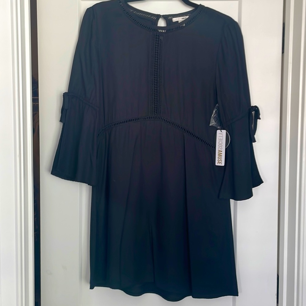 New with tags never worn black midi dress. Bell sleeve